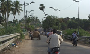 Men and women from local villages bring their bullock carts to load them up with sand, which is then sold on at about £9 per load.