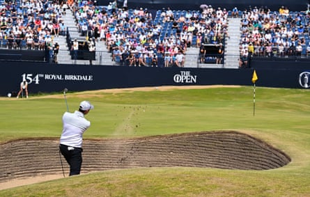 Joe Dean plays from a greenside bunker on the 18th.