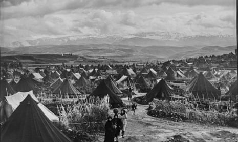 Palestinian refugees walk through the Nahr el-Bared refugee camp in Lebanon in 1952 (AP Photo/S.Madver, UNRWA Photo Archives)