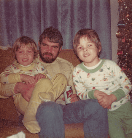 A man pinch a beard sitting connected a sofa pinch 2 young boys either side