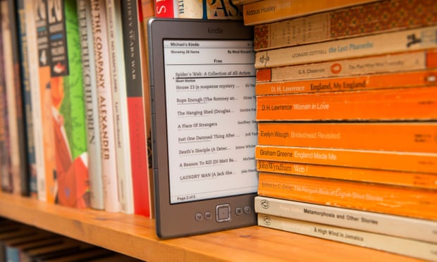 An Amazon kindle in a bookshelf.