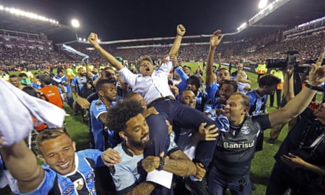 Brazil’s Gremio soccer players carry their coach Renato Gaucho after winning the 2017 Copa Libertadores championship following their game against Argentina’s Lanus in Buenos Aires