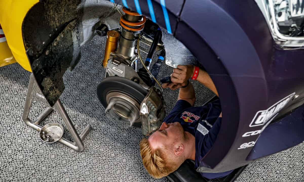 Man repairing racing car