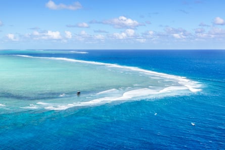 The judges tower looks tiny perched on the open ocean reef known as Cloudbreak in Fiji.