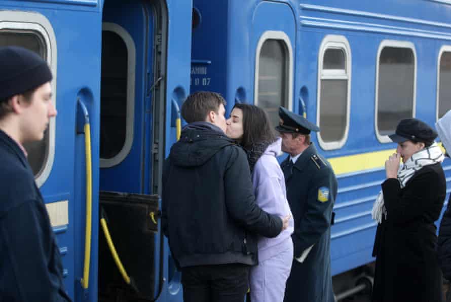 Ukrainian refugees say goodbye while boarding the train to Przemysl, Poland, in Odesa, Ukraine.