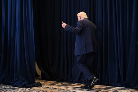 Trump leaves after speaking to reporters during a news conference.