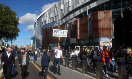 A fan protests against Tottenham's ownership
