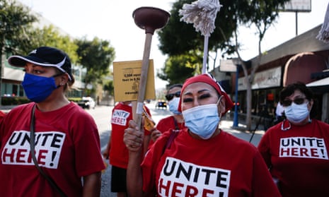 A group of West Hollywood hotel workers march ahead of a city council vote on a hotel worker protection policy, on 19 July 2021.