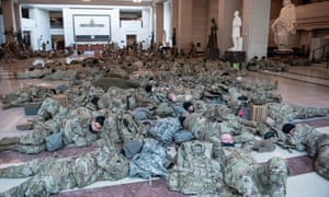 Members of the National Guard rest in the Capitol Visitors Center on Capitol Hill yesterday, ahead of an expected House vote to impeach President Donald Trump.