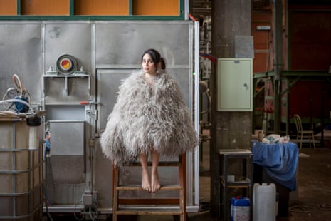 Export manager Eleonora Corri with a coat of ostrich feathers in the workshop of the feather sorters Minardi Piume in Lugo, Italy.