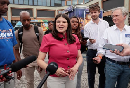 a woman speaks into microphones