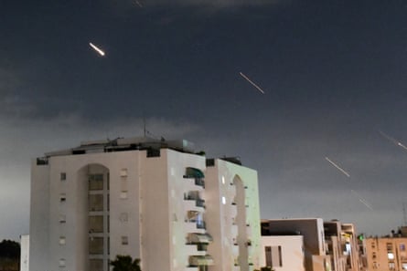 Flashes of light in the sky over blocks of flats