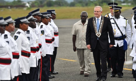 Australian prime minister Scott Morrison and Solomon Islands prime minister Manasseh Sogavare inspect an honour guard after arriving at Honiara international airport.