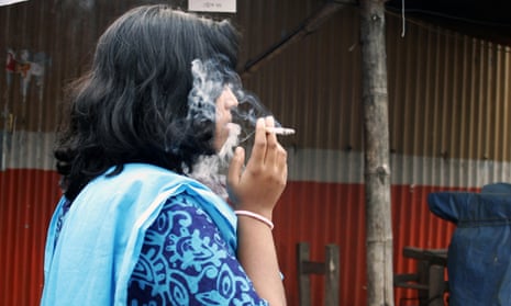 A Bangladeshi woman smokes a cigarette in Dhaka