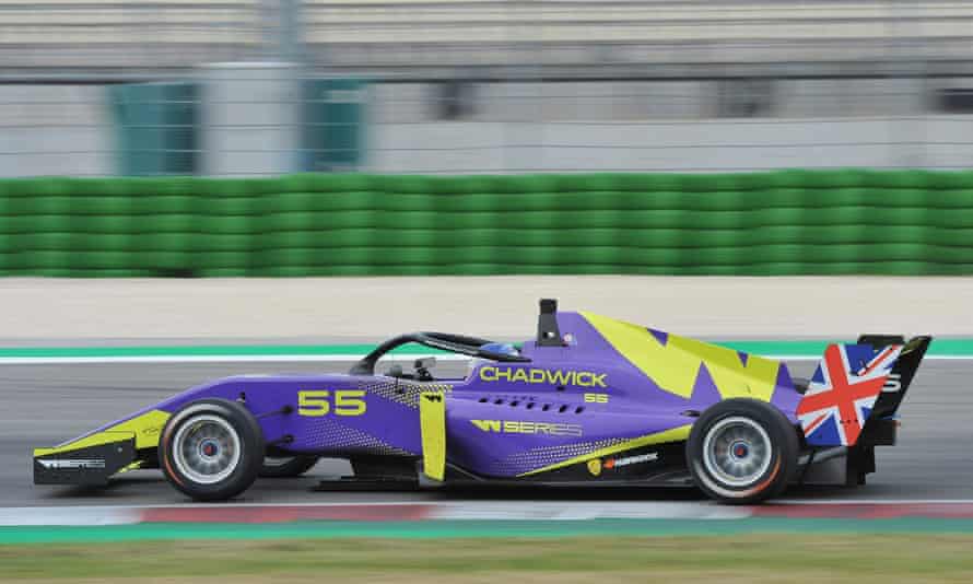 A purple racing car with green markings and 'Chadwick' written on the side, on a race track