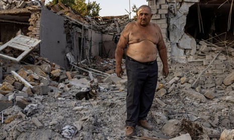 Man standing in the middle of a pile of rubble