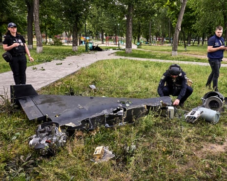 Ukrainian experts inspect debris at the site of a drone strike in Kharkiv, northeastern Ukraine.