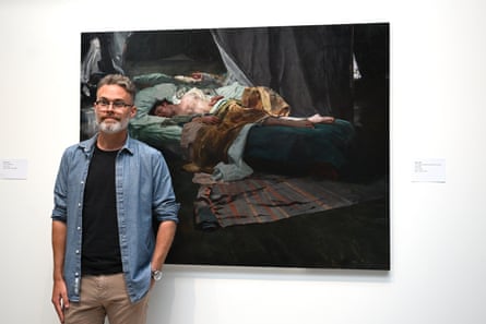 Sean Layh with his portrait of Jacob Collins.