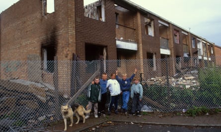 Children pose near derelict houses in the Collyhurst neighbourhood of Manchester.