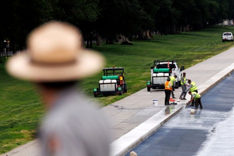 A park ranger watched workers scrub an edge of the Lincoln Memorial reflecting pool on 8 June.