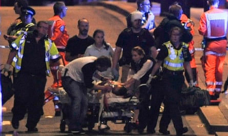 Police and members of the emergency services attend to victims of a terror attack on London Bridge.