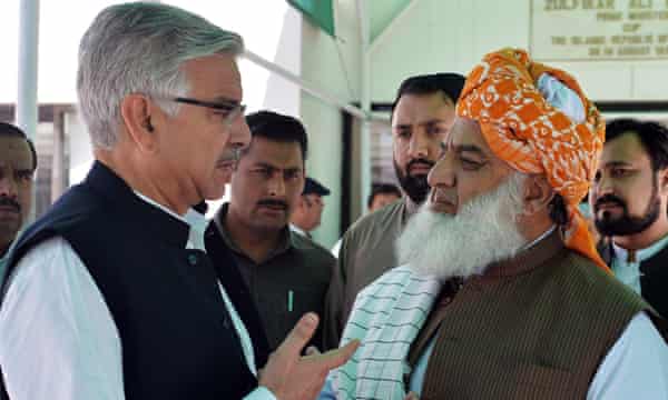 Pakistan’s defence minister (left) and the chief of the country’s religious hardline party Jamiat Ulema-e-Islam talk at Parliament House in Islamabad.
