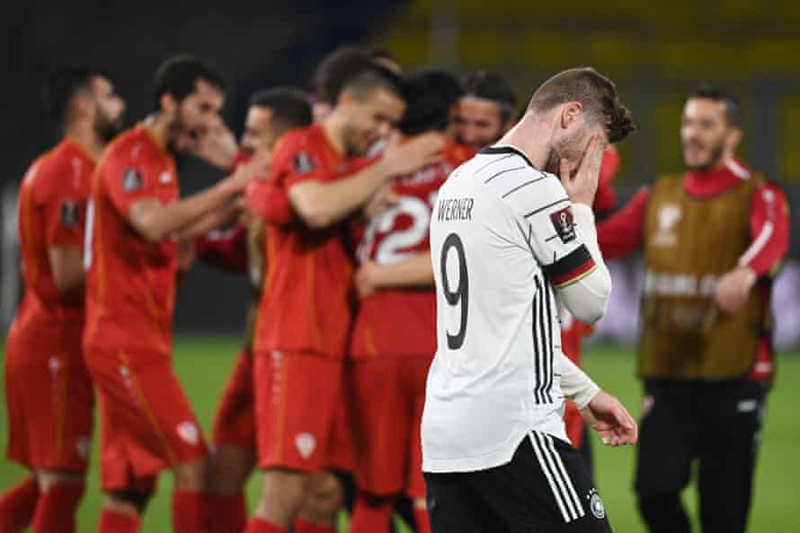 North Macedonia players celebrate as Germany’s forward Timo Werner despairs.