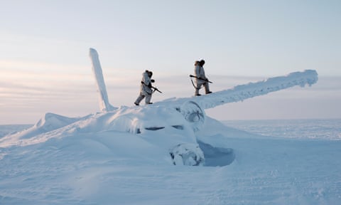 Canadian Arctic Operations Advisors scale the decades-old wreckage of an airplane in temperatures below minus 50 degrees Celsius. They are on reconnaissance outside Resolute Bay on Cornwallis Island, Nunavut, Canada.