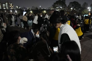 People watch the moon through telescopes in Goyang, South Korea