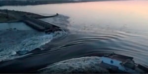 In this image taken from a video released by the Ukrainian Presidential Office, water runs through a large hole in the Kakhovka dam.