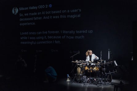 A woman plays drums on a dimly lit stage beneath a projected social media post, in The Alonetimes