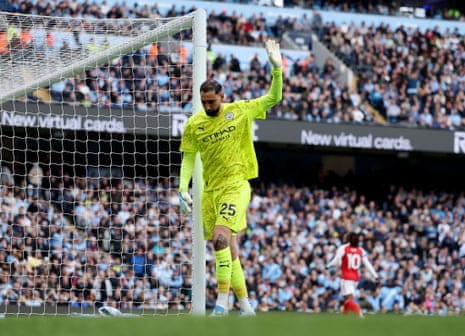 Gianluigi Donnarumma of Manchester City apologises after miss kicking his clearance straight to Kai Havertz of Arsenal.