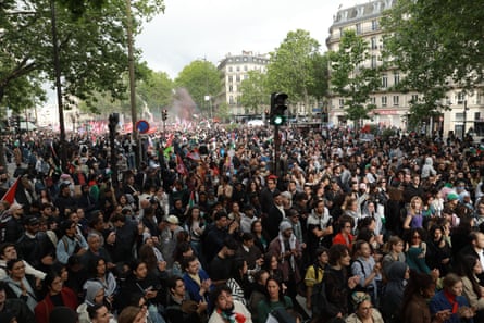 Hundreds of protesters carrying Palestinian flags and banners gather in Paris.