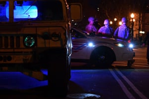 National Guardsmen sit on a police car at a junction