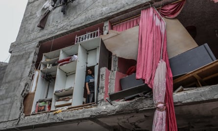 A man stands inside a home in Rafah destroyed by an Israeli attack.