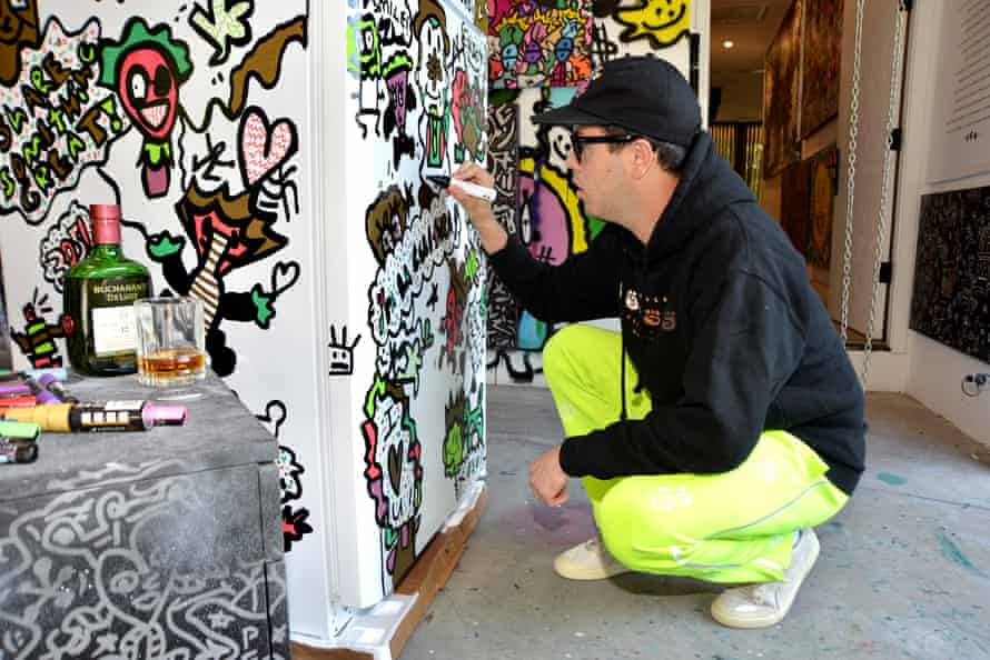 The Miami artist Vic Garcia painting a new community fridge.