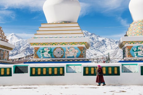 A lone figure walks in front of a Buddhist temple in Leh.