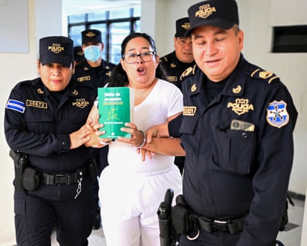 A woman is is escorted by police