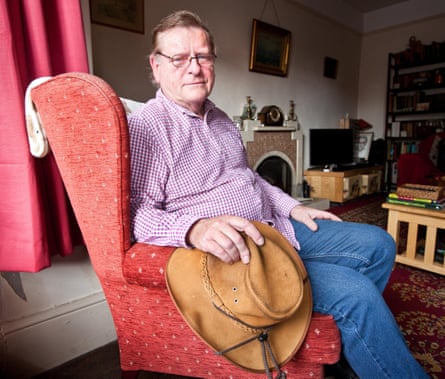 Roger Lilley sits in an armchair at his home.