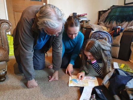 Jenny Johnson’s family look at a map.
