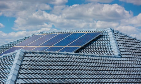 A blue house rooftop with a set of solar panels on it