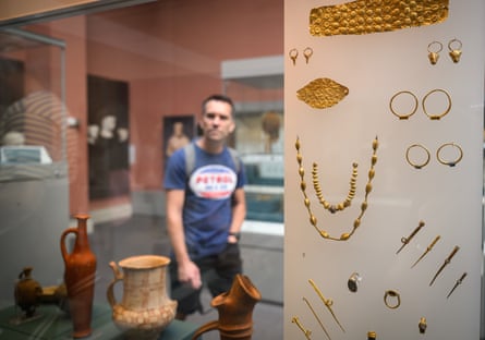A man walks past a jewellery exhibition at the British Museum.