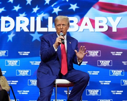 a man in a suit talks into a microphone