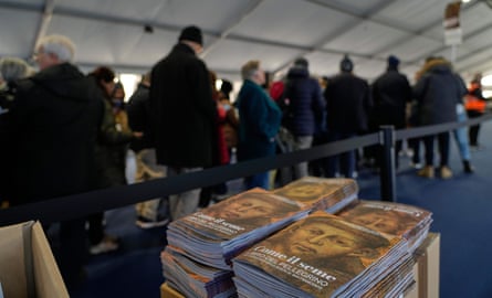 Pilgrims pass through security checks as they queue to honour the bones of Saint Francis