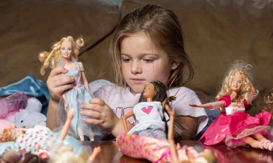 Playing with her Barbie dolls