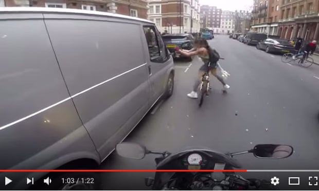 Screengrab of viral video appearing to show a female cyclist in London tearing the wing mirror from the van of men who catcalled her.