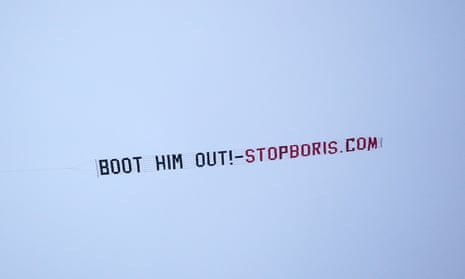 A sign protesting against British Prime Minister, Boris Johnson, is flown over the Premier League match at Old Trafford, Manchester