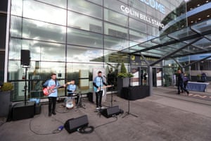 A band play outside the entrance to the Colin Bell Stand at the Etihad Stadium.