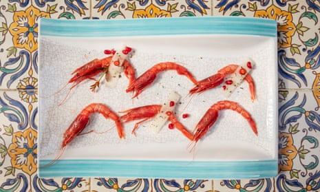 Uncooked red prawns with melon, chili pepper and pomegranate