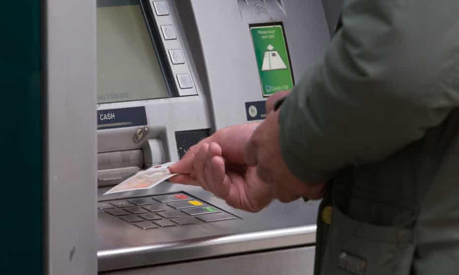 A man withdrawing money from a cash machine